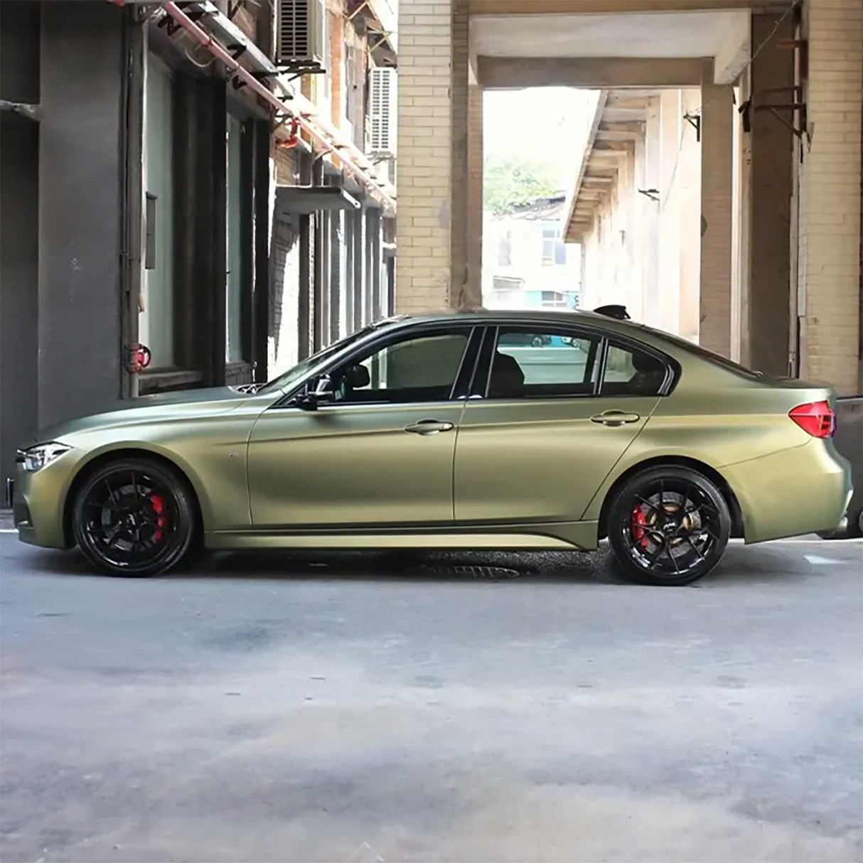 side shot of a car wrapped in metallic lighting green car wrap