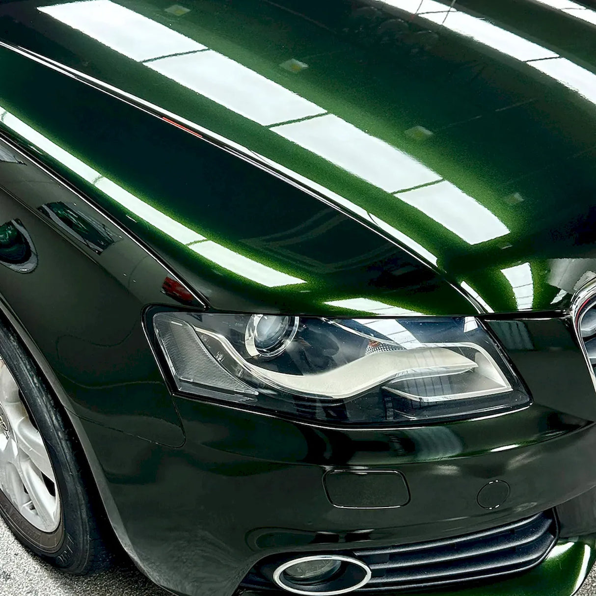 blackish green car wrap installed on a large sedan