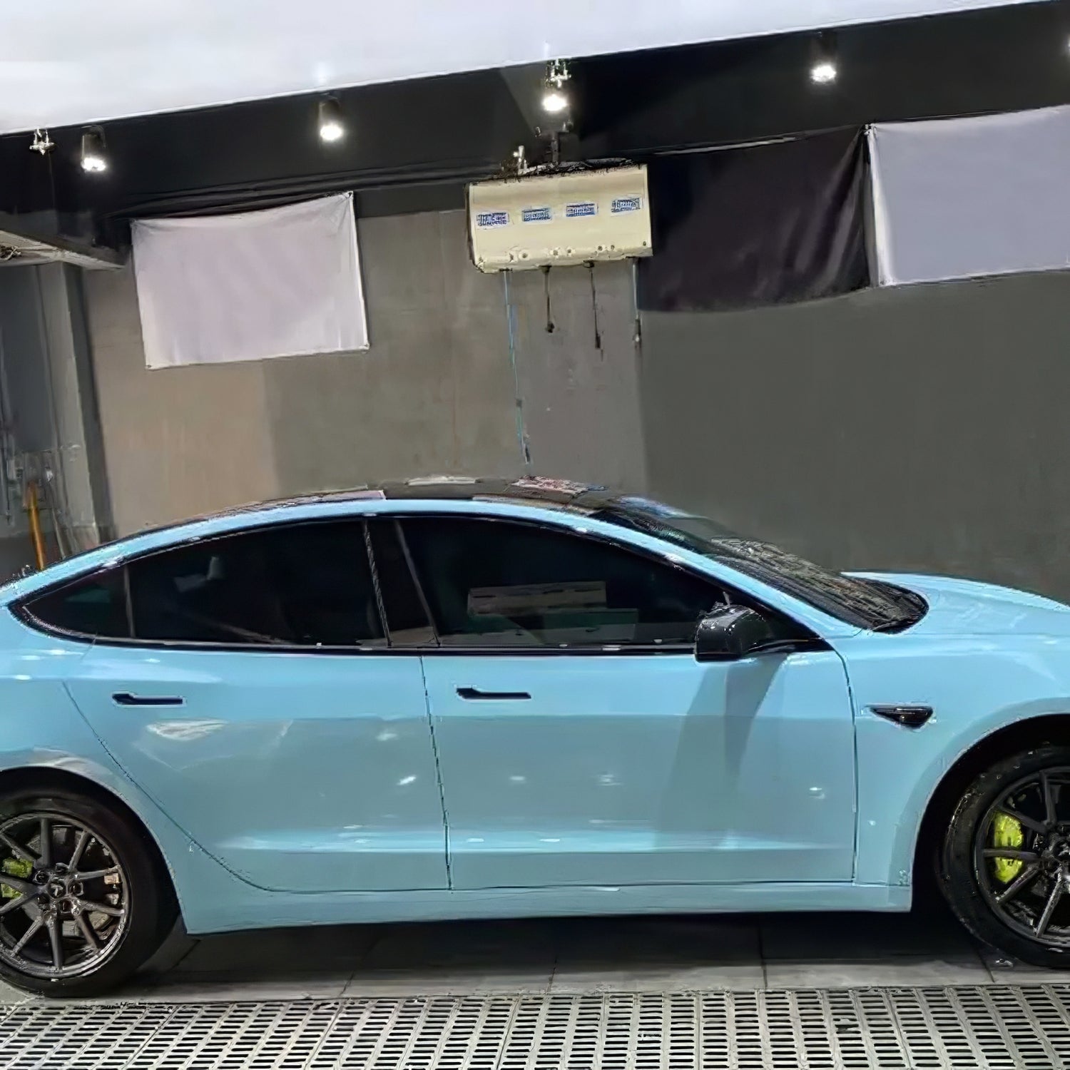 side shot of a tesla model 3 wrapped in crystal sea breeze blue