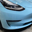 up close corner of a tesla model 3 wrapped in crystal sea breeze blue