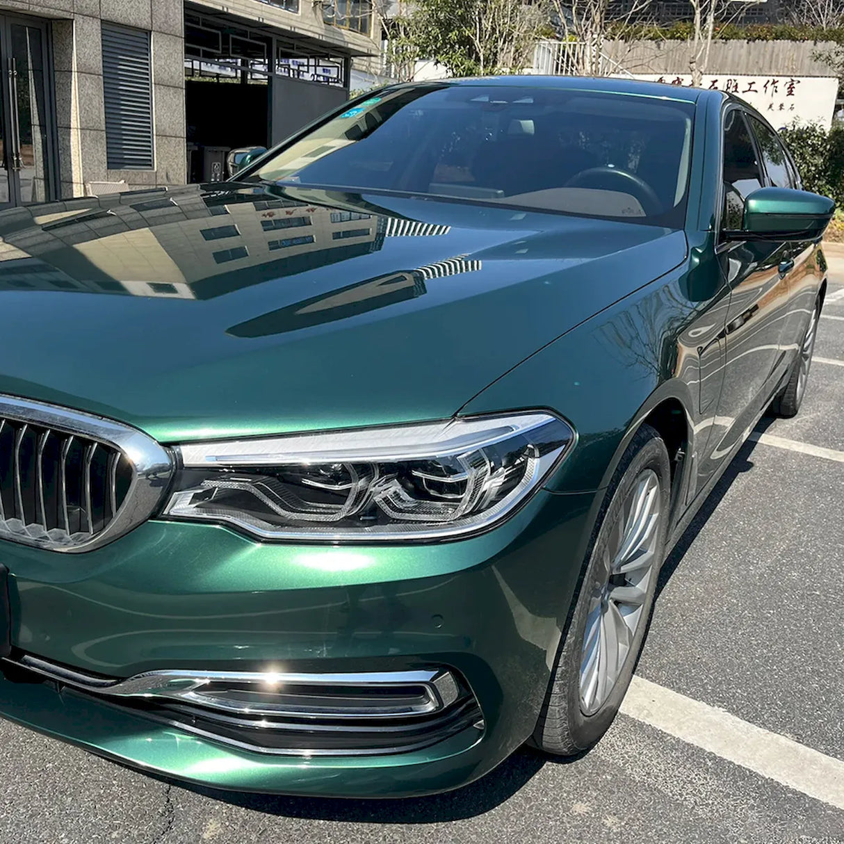 up close look at a car wrapped in emerald green car wrap