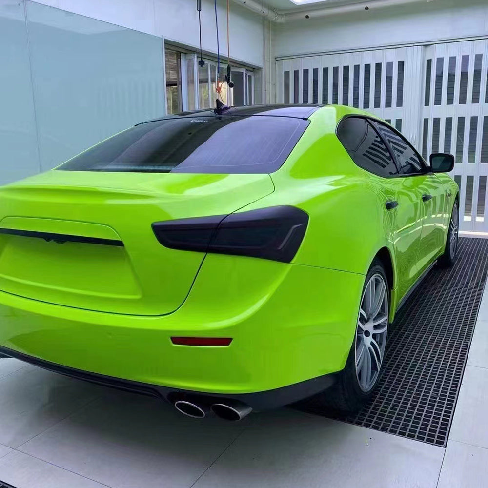 gloss apple green car wrap being installed in a shop