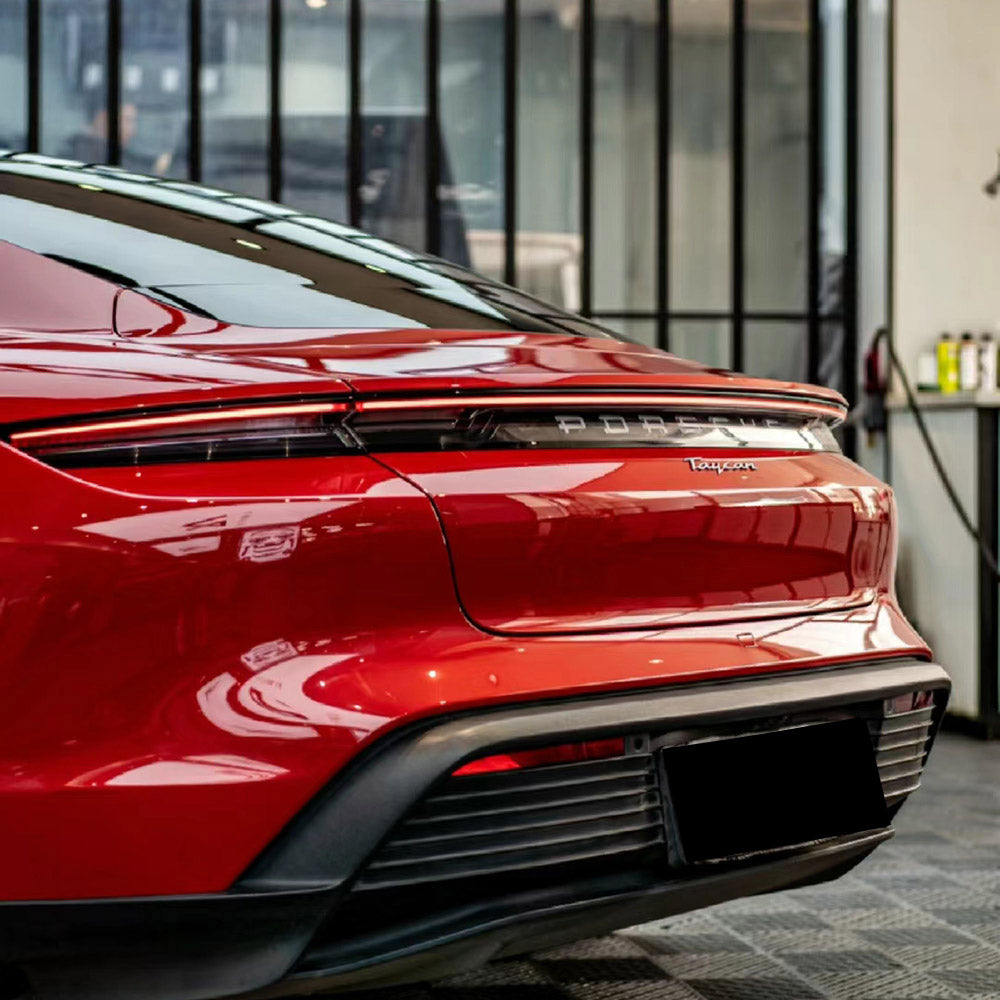 gloss carmine red car wrap on a rear of a sports car