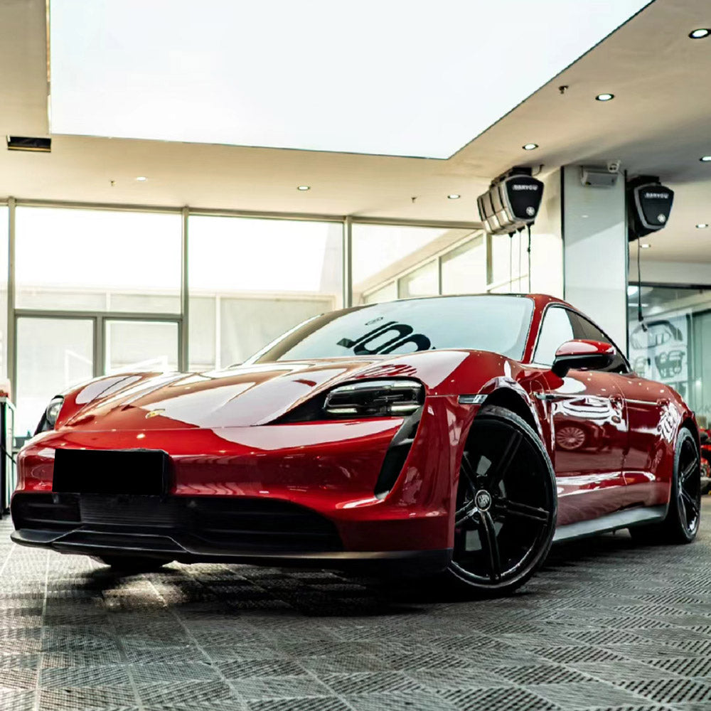 a sports sedan wrapped in gloss carmine red car wrap