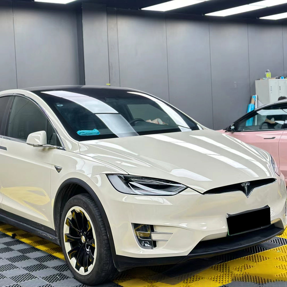 gloss coopers white car wrap being installed on a vehicle