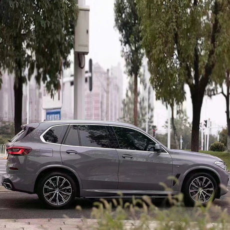 side angle of the gloss dark nado gray car wrap that's installed on a vehicle