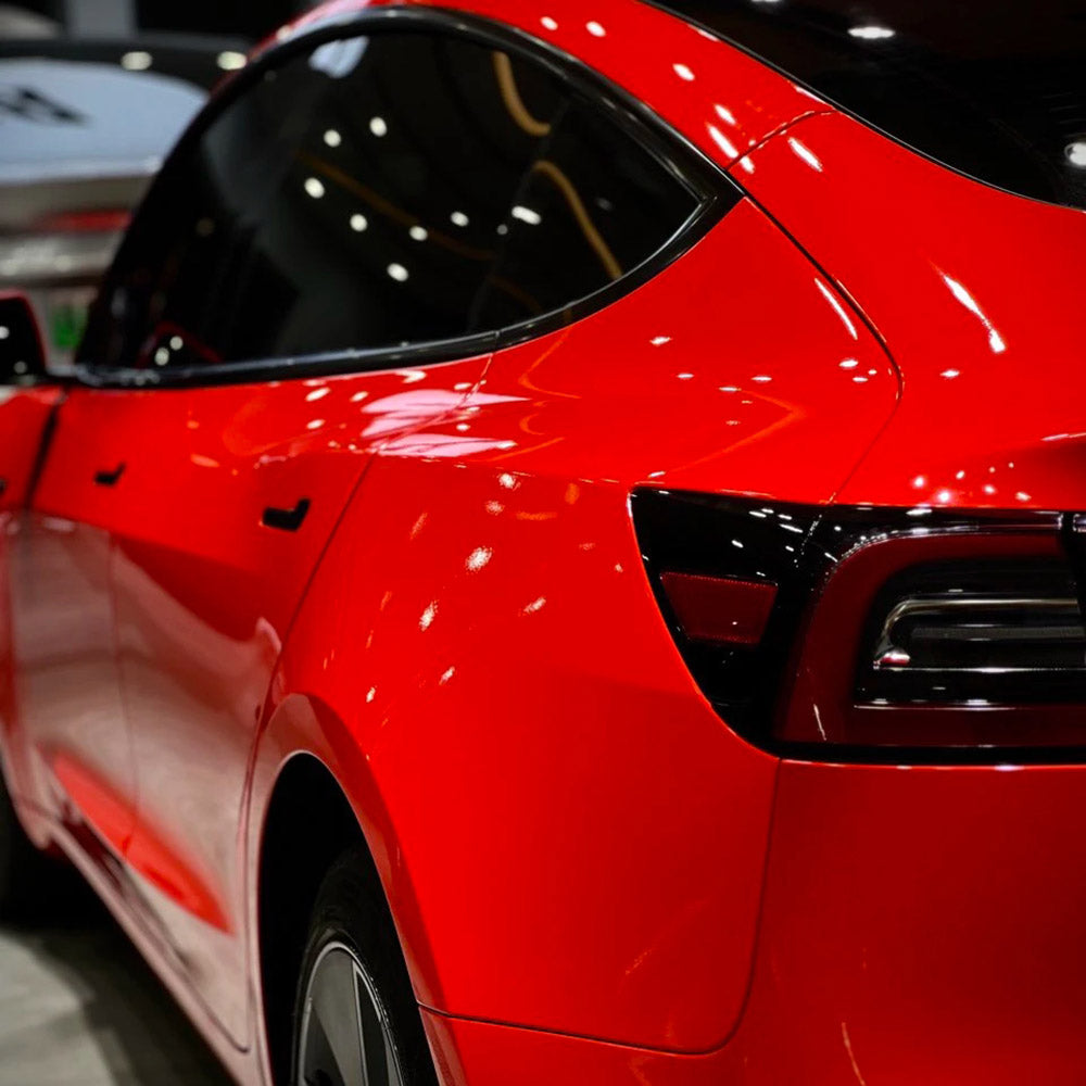 gloss ferrari red car wrap installed on a tesla