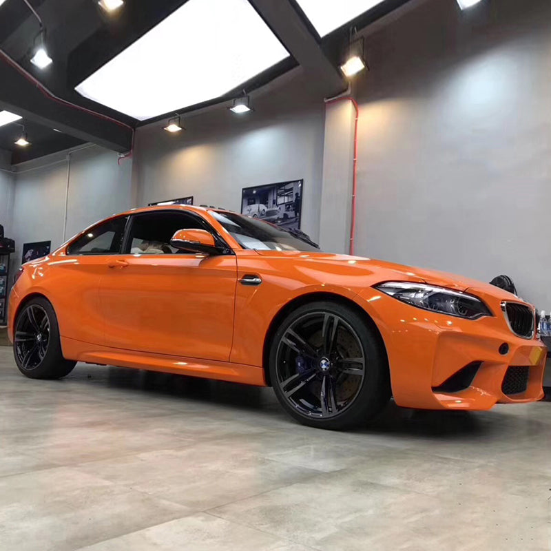 gloss flame orange car wrap on a sports car