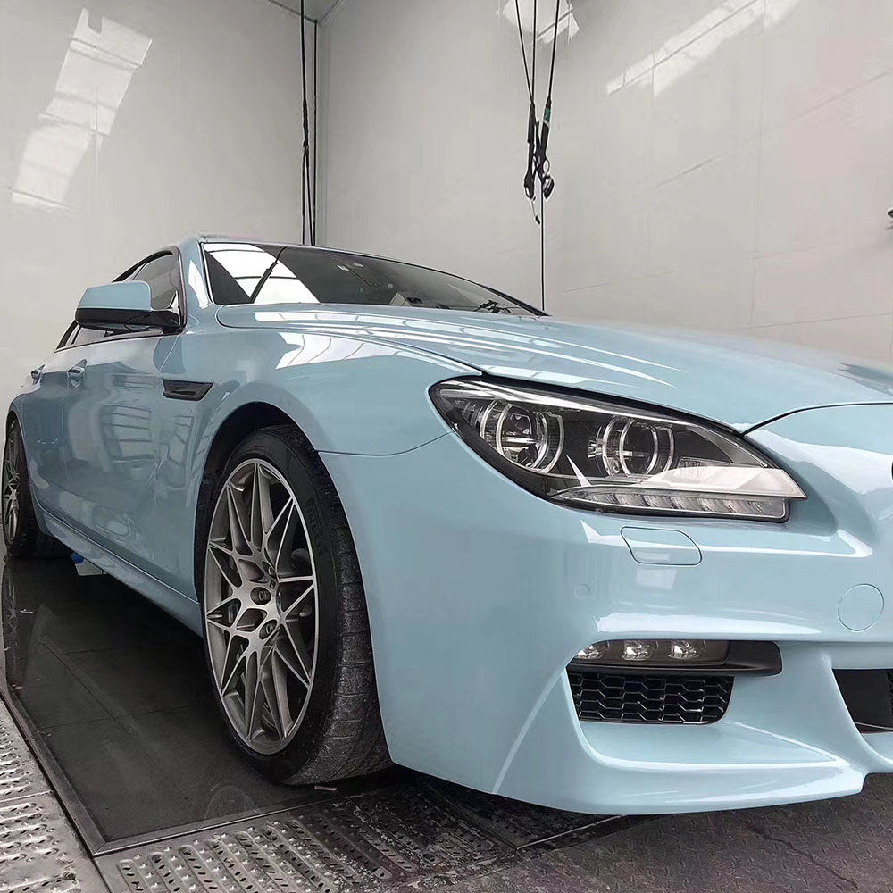 car being wrapped in gloss ice blue car wrap