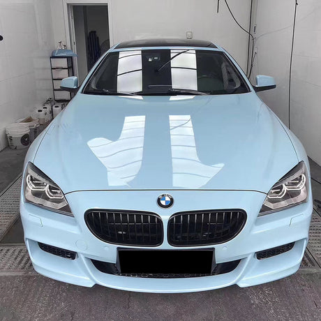 gloss ice blue car wrap being installed