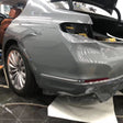gloss light cement gray car wrap being installed on a vehicle