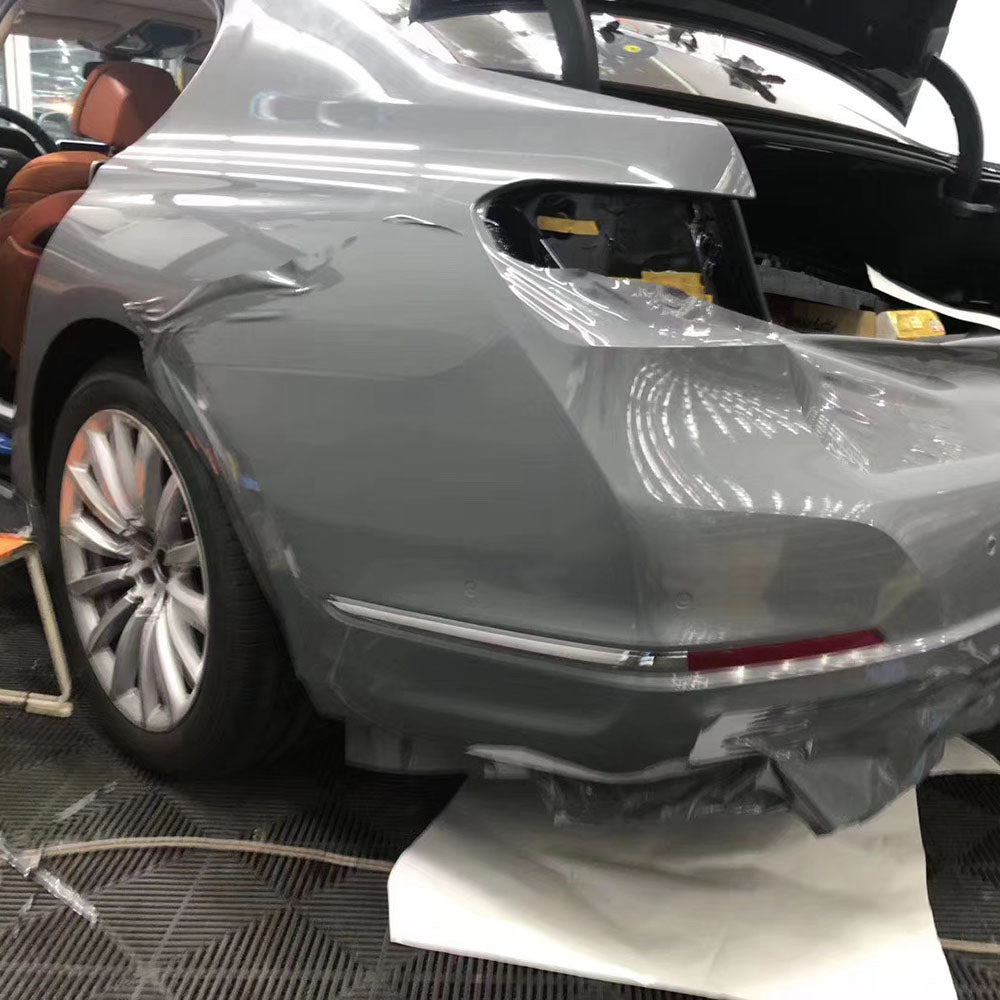 gloss light cement gray car wrap being installed on a vehicle