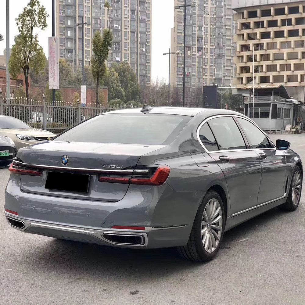 gloss light cement gray car wrap on a car