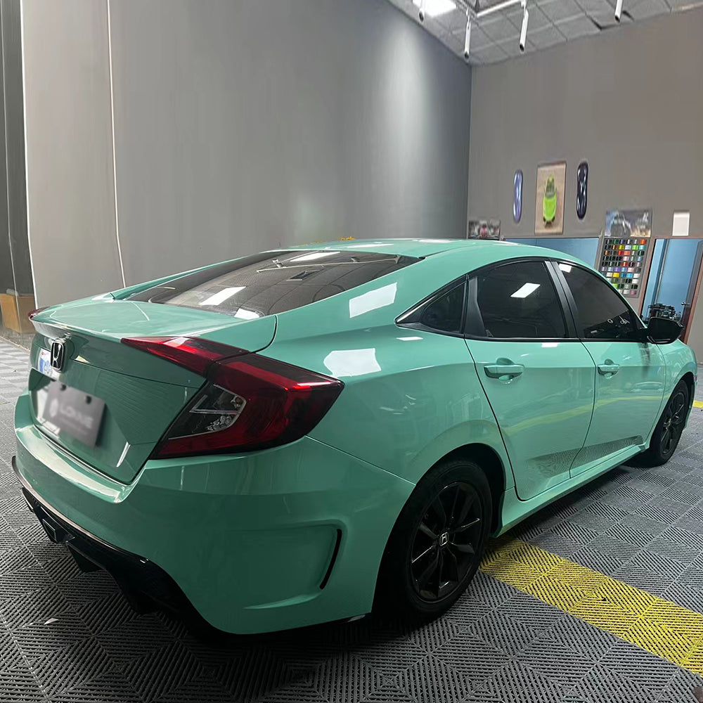 car being wrapped in gloss mint green car wrap