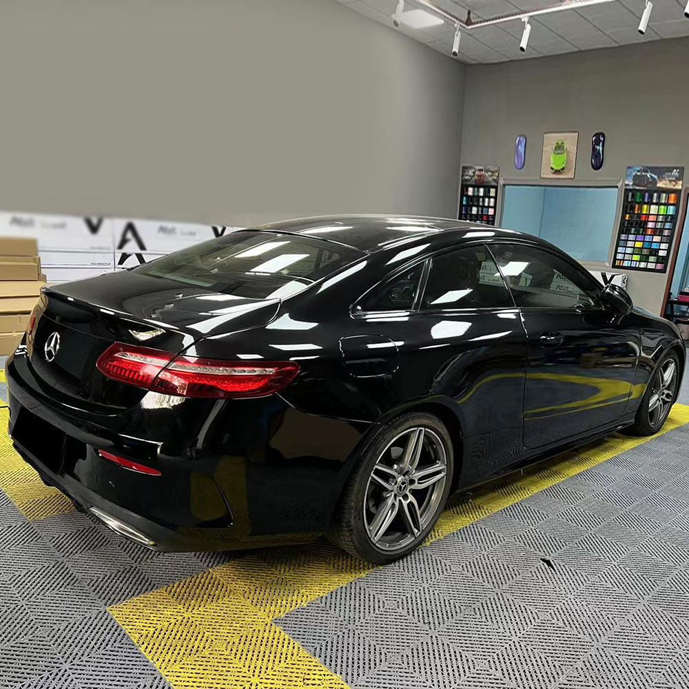 car being wrapped with gloss piano black car wrap