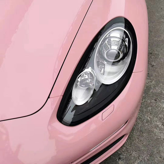 close up shot of the front of a car wrapped in gloss pink red car wrap