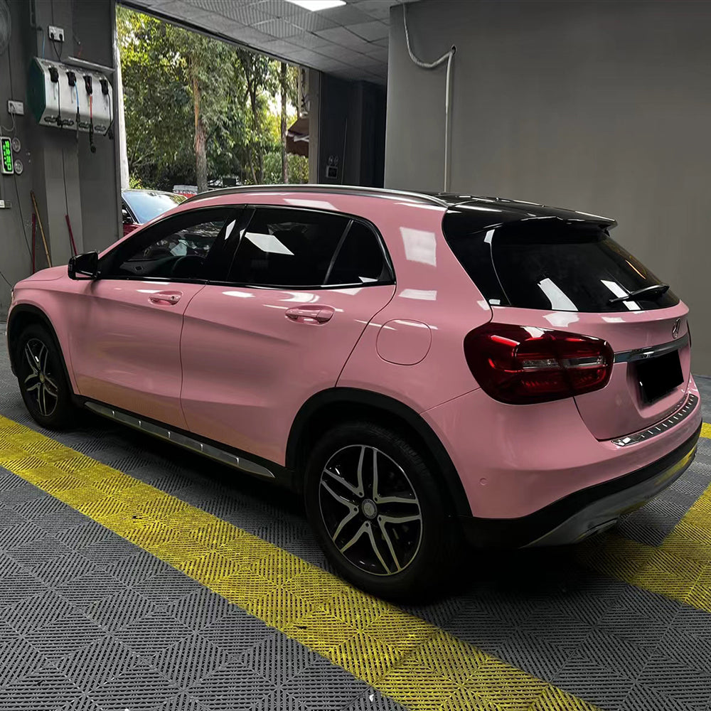 gloss rouge pink car wrap being installed on a vehicle