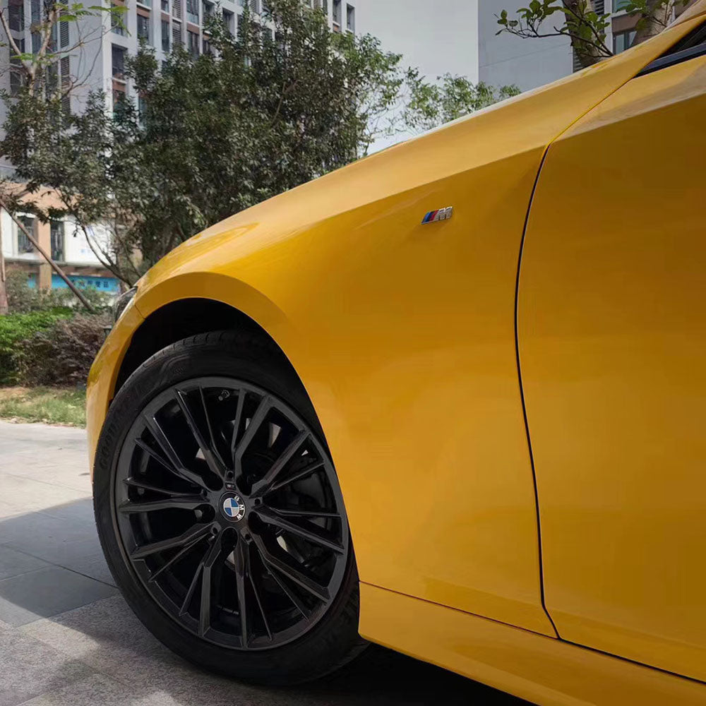 close up shot of gloss sunflower yellow car wrap