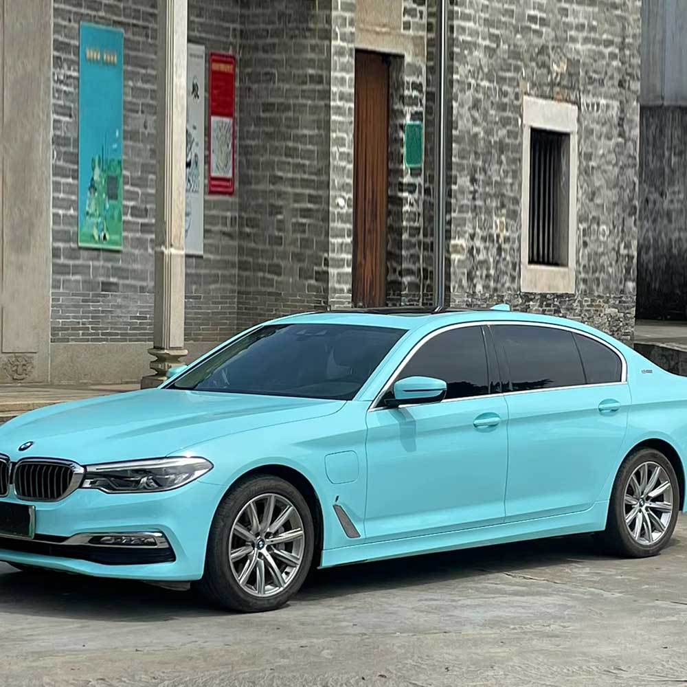 car wrapped in gloss tanager blue car wrap