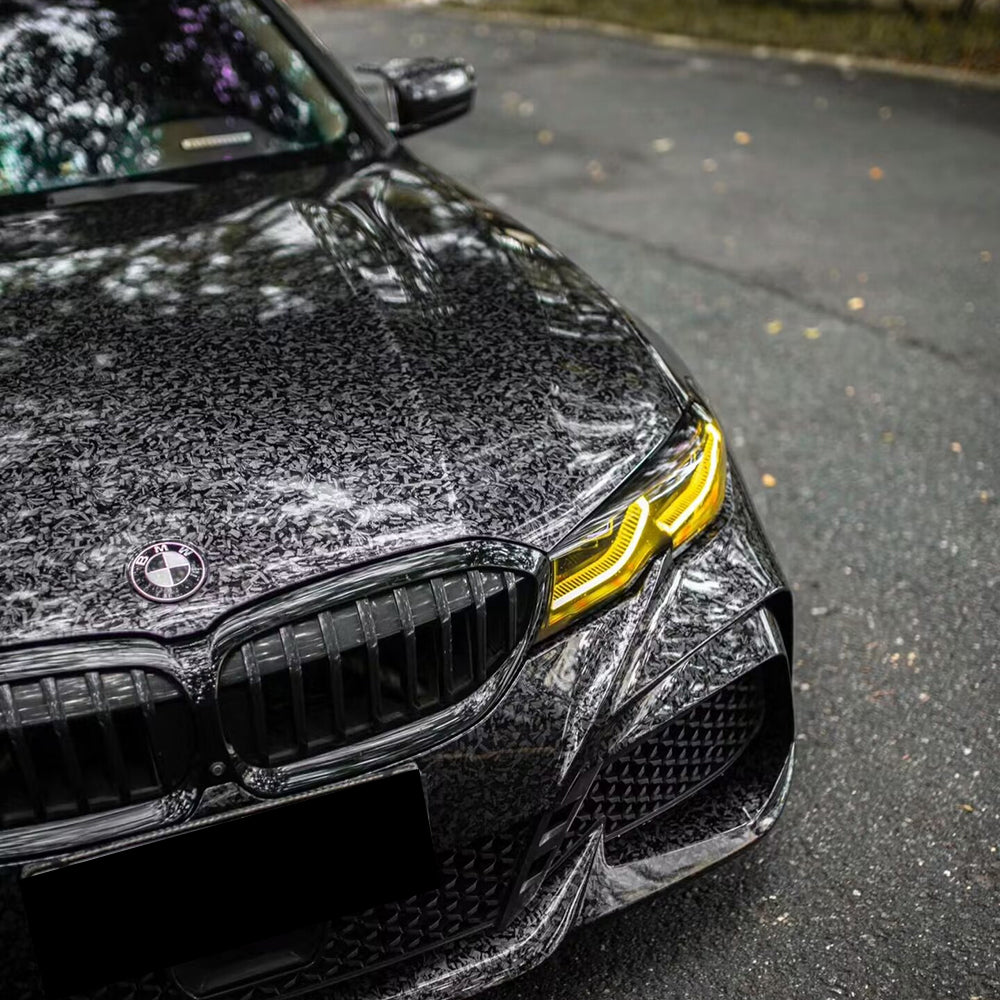 gloss charcoal forged carbon black car wrap on a car
