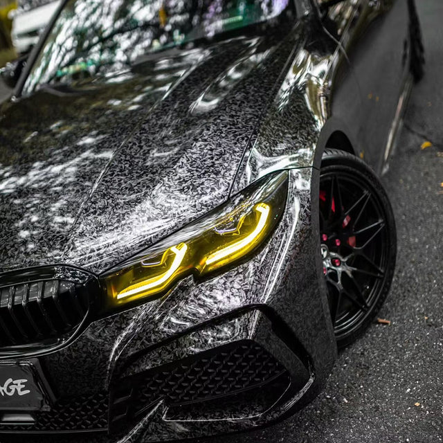 close up shot of gloss charcoal forged carbon black car wrap