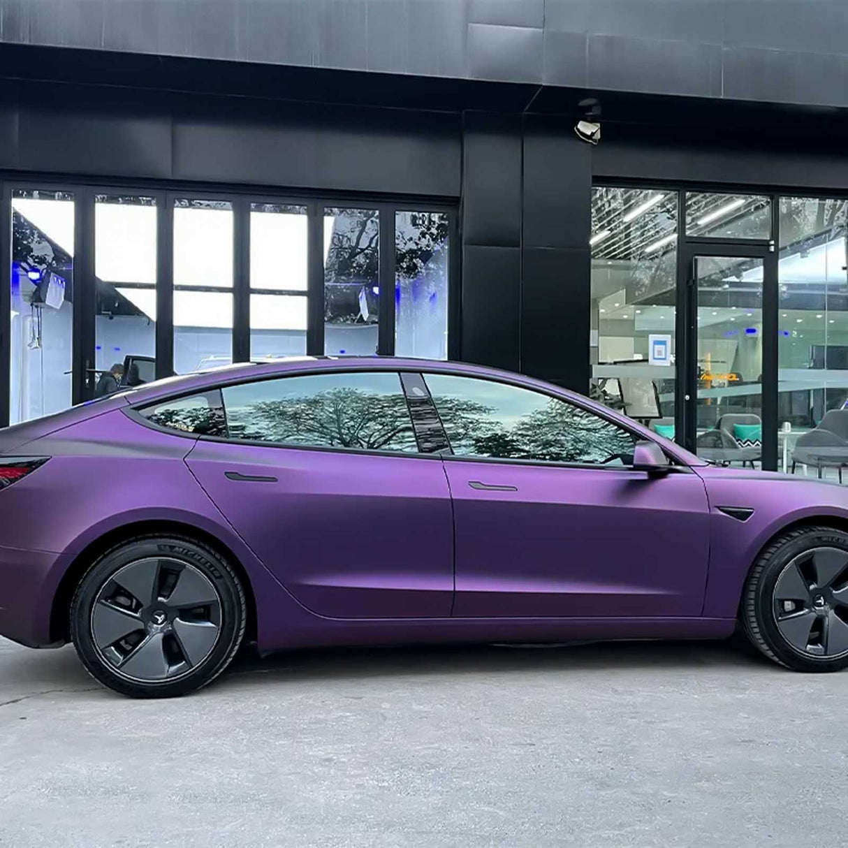 side shot of a vehicle wrapped with matte purple car wrap