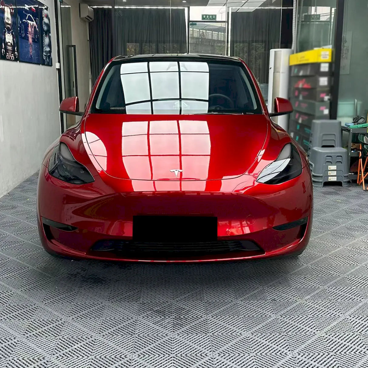 metallic cherry red vinyl wrap being installed on a tesla