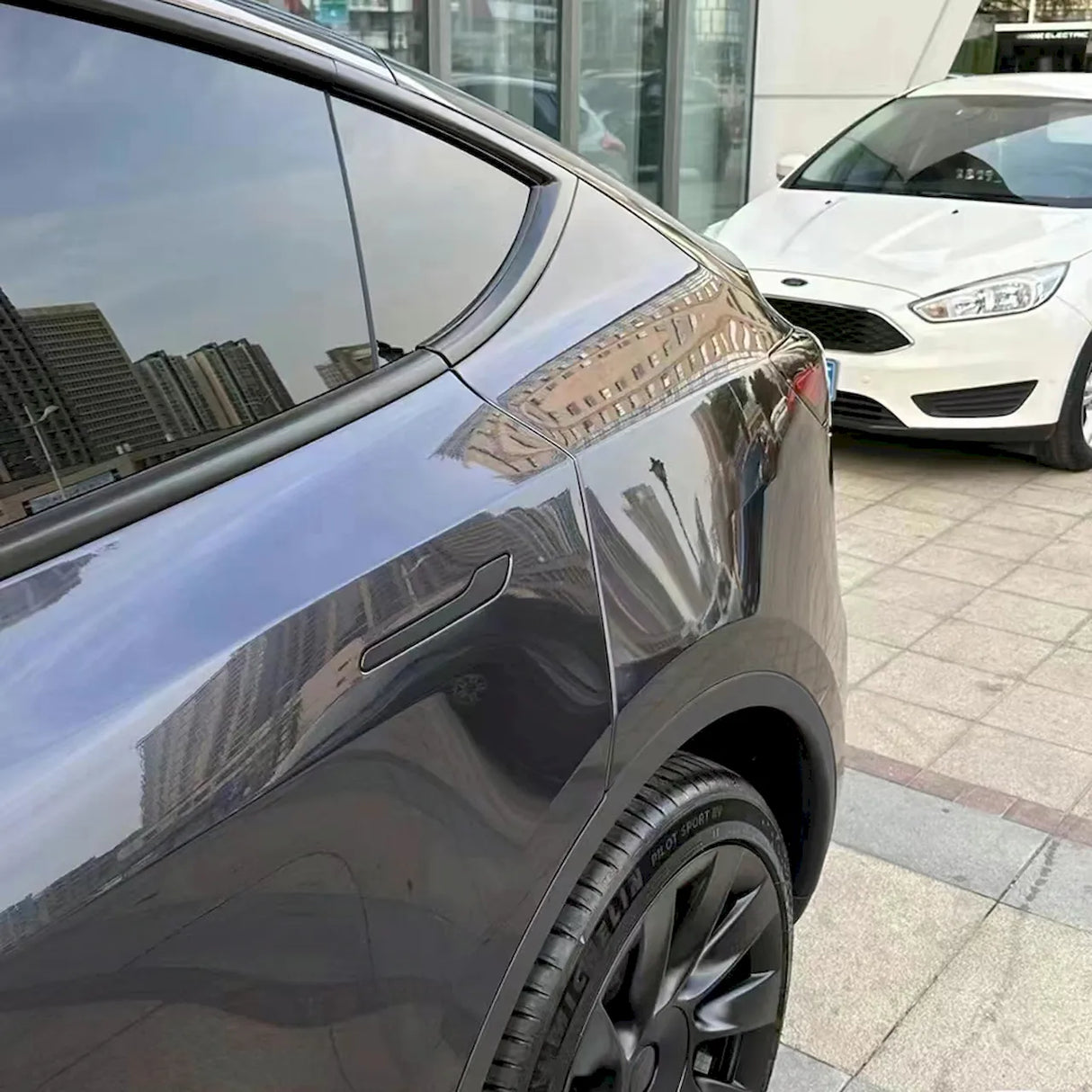 metallic shadow blue gray vinyl wrap installed on a car