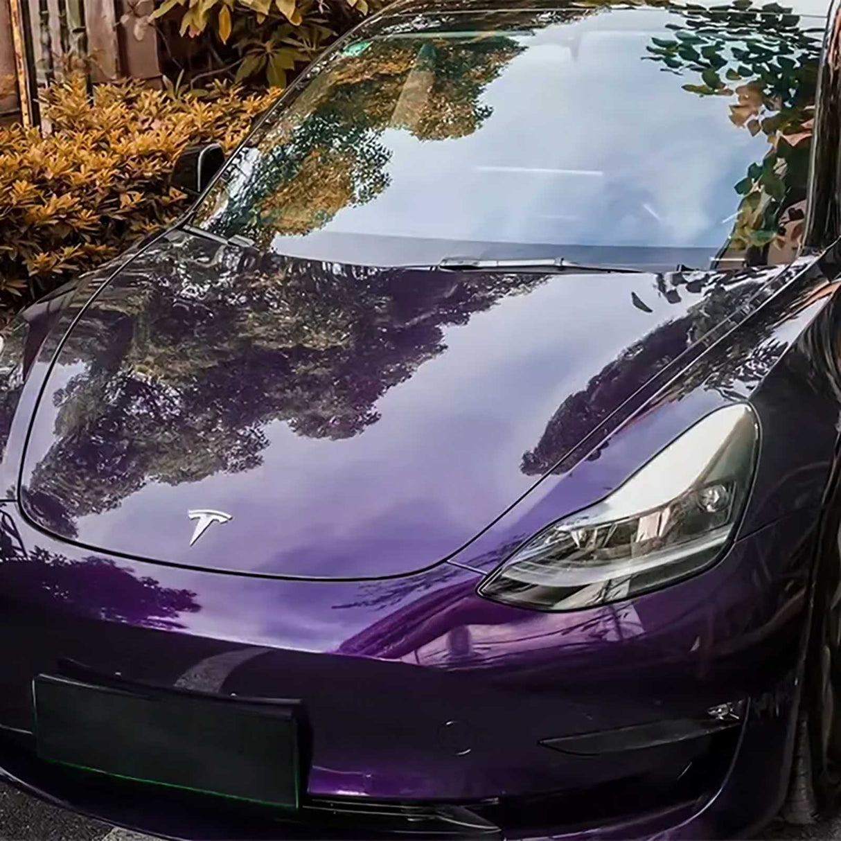 close up shot of a tesla wrapped in venetian purple car wrap