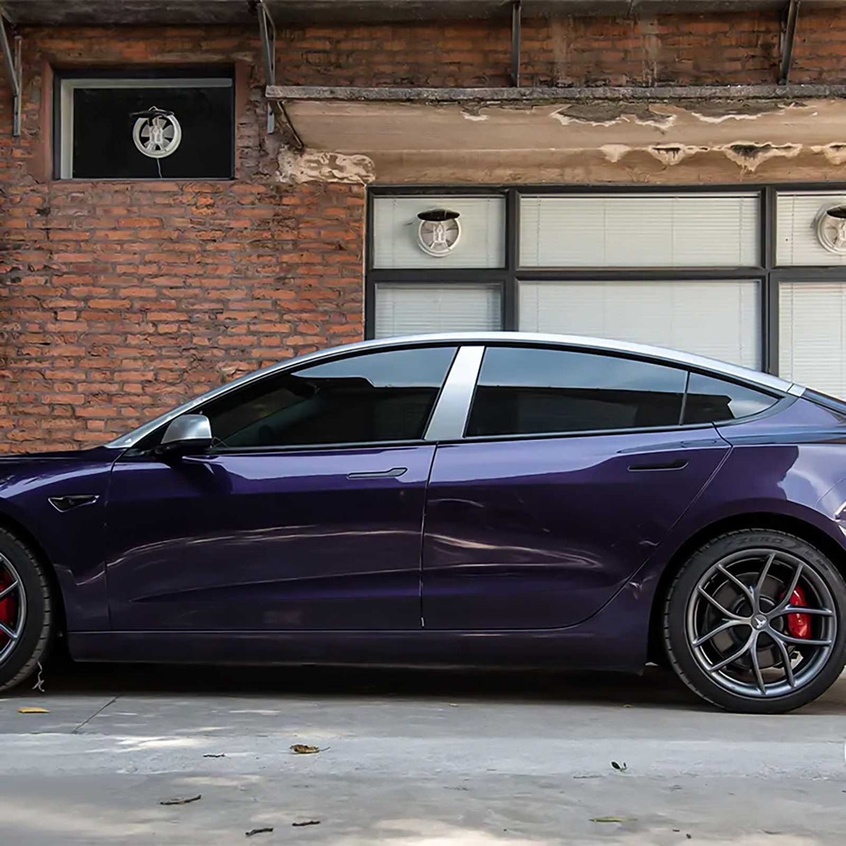 side view of a tesla wrapped in venetian purple car wrap