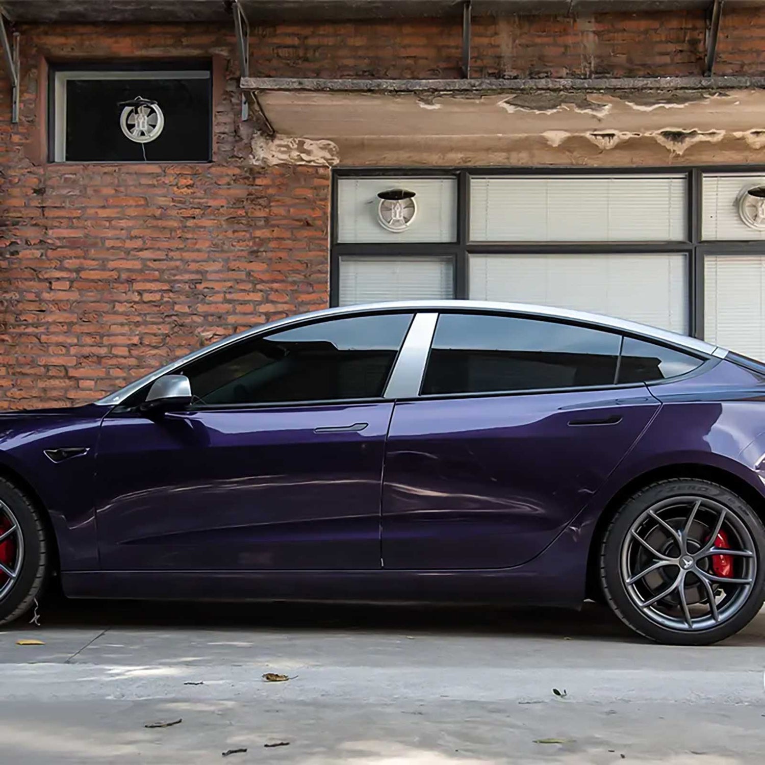 side view of a tesla wrapped in venetian purple car wrap