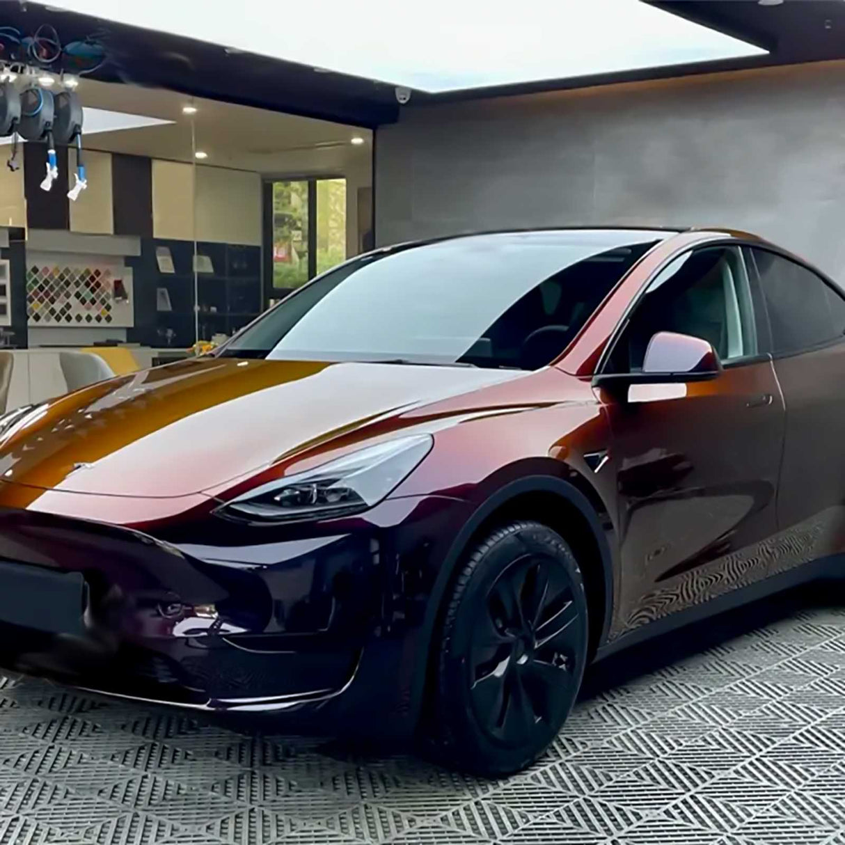 tesla with phantom red car wrap at a shop