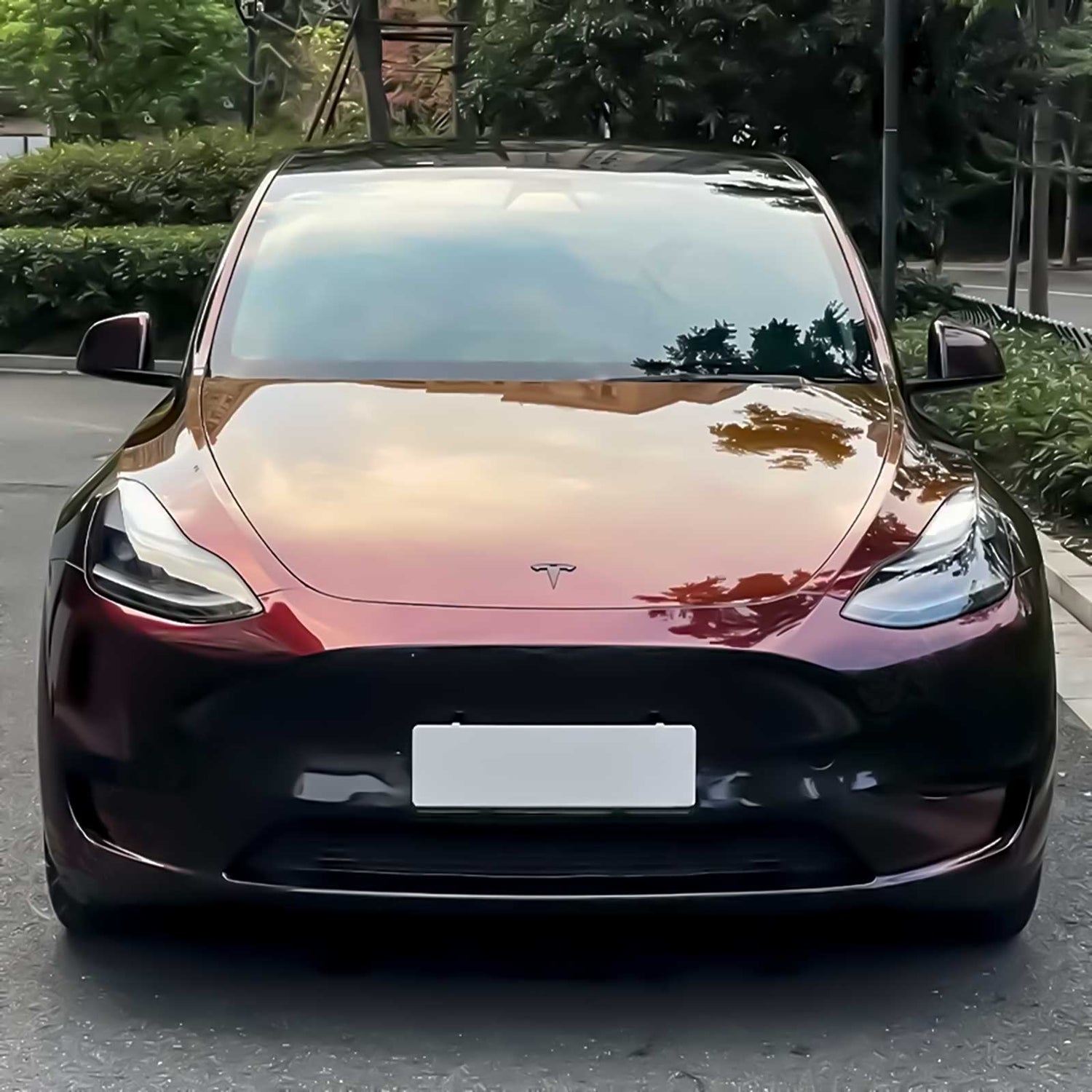 front view of a tesla model y with phantom red car wrap
