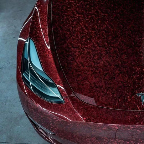 corner of a car wrapped in red forged carbon car wrap