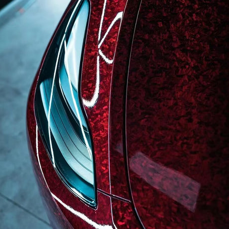 front of a car wrapped in red forged carbon car wrap