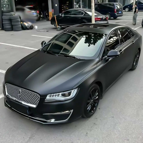 satin black vehicle wrap being shown on a 4 door lincoln