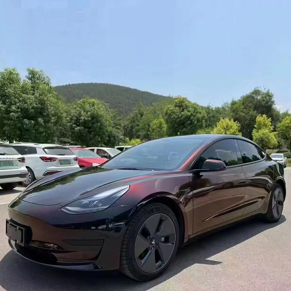 night elt glossy flip black red color shifting car wrap in the sun