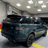 blackish green car wrap being installed on a suv