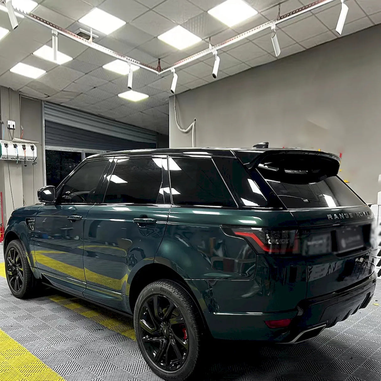 blackish green car vinyl wrap being installed