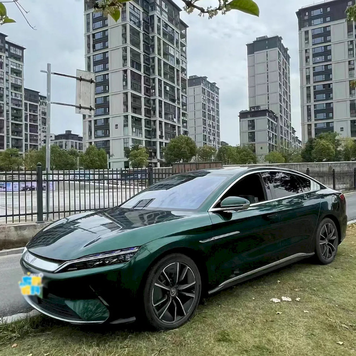 a sedan wrapped in ceramic jade green vinyl car wrap