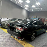 emerald green car wrap installed on a sedan