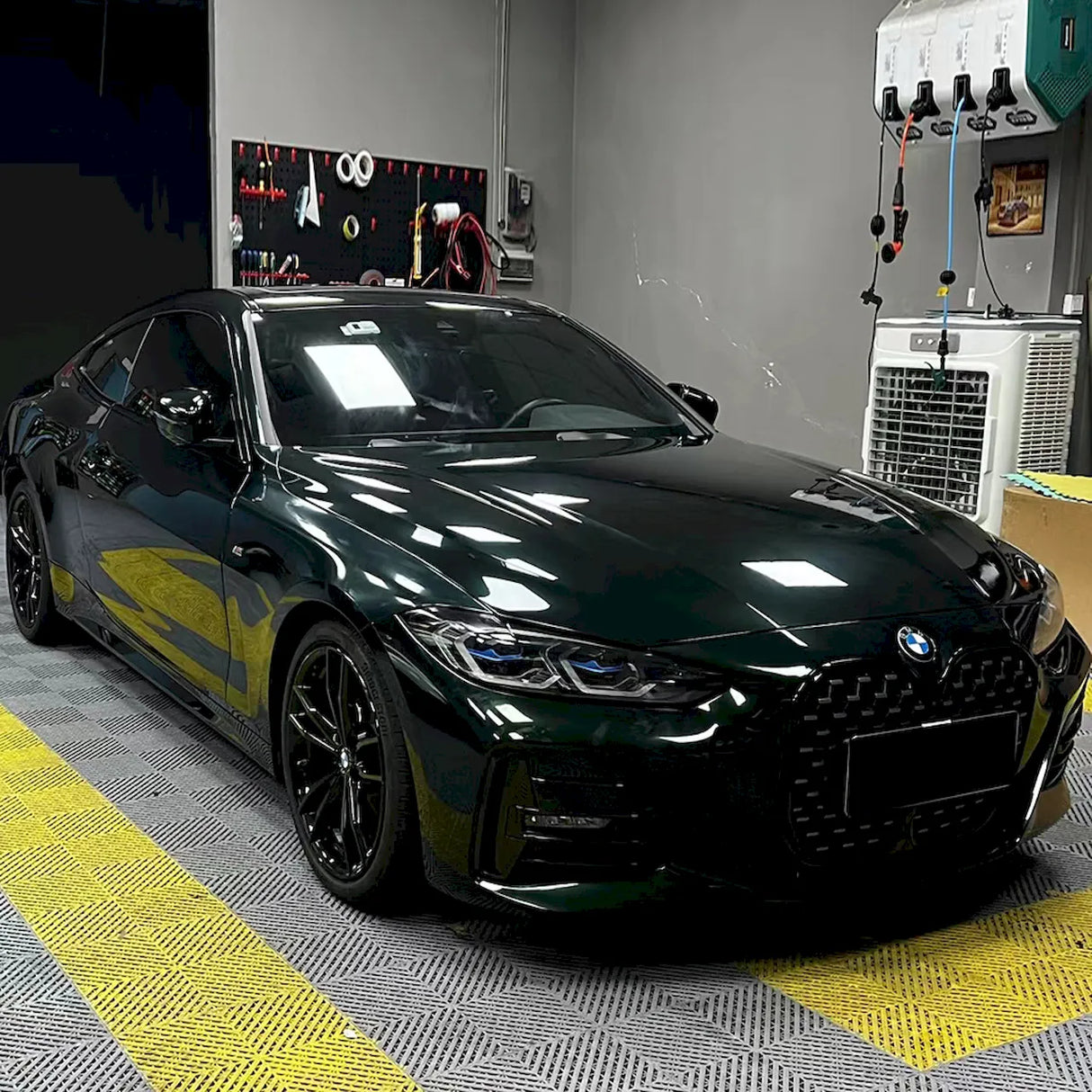 installation of dark emerald green car vinyl wrap