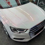 sparkling pollen pink car wrap being installed on a vehicle