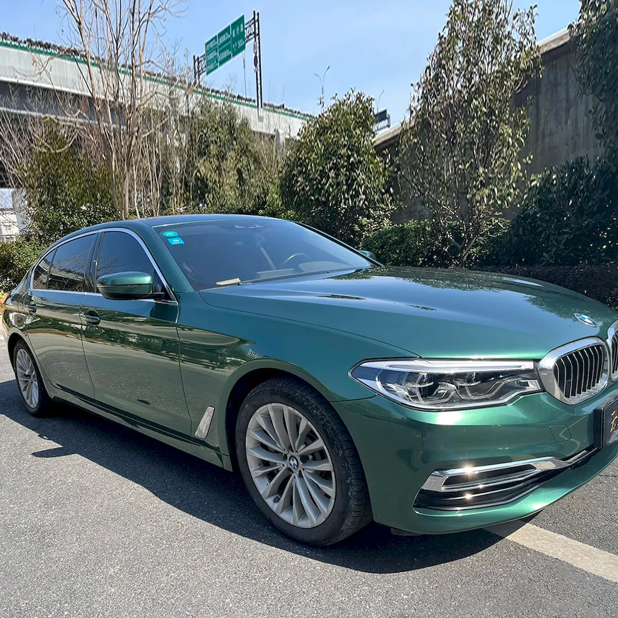 emerald green car wrap installed on a car