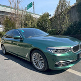 emerald green car wrap installed on a car