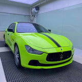 gloss apple green car wrap being installed on a car