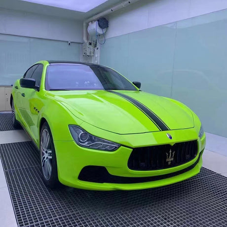 gloss apple green car wrap being installed on a car