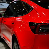 gloss ferrari red car wrap installed on a tesla