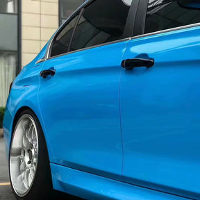 side of a car wrapped in gloss ice cream blue car wrap