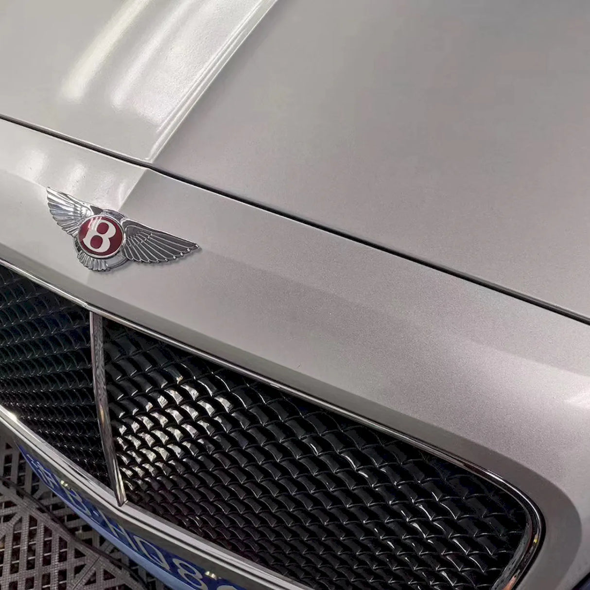 gloss silver car wrap installed on a luxury vehicle
